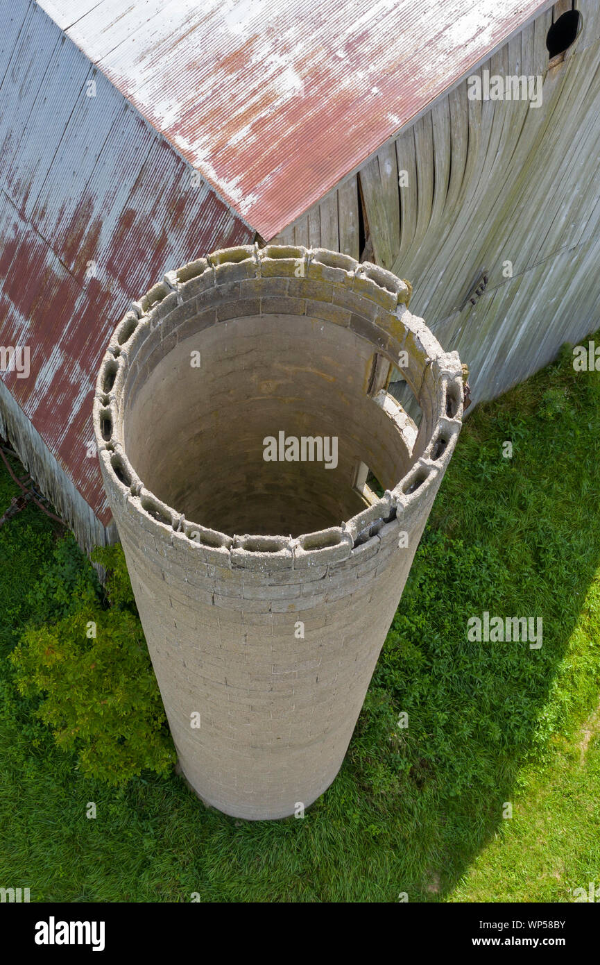 Adair, Michigan - An old, decrepit barn with the remains of a concrete silo. Stock Photo