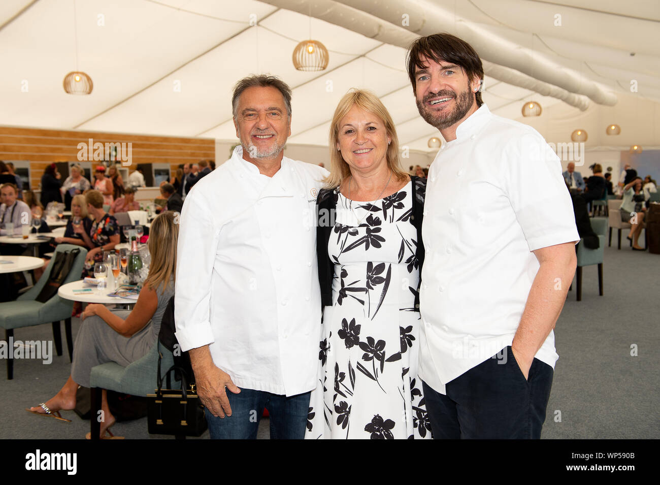 Italian Tourist Board Festival of Food and Wine, Ascot Racecourse, Ascot, Berkshire, UK. 7th Sep, 2019. Janette Garden from Sandhurst is delighted to have her photo taken with celebrity chef Raymond Blanc OBE and Chef Eric Lanlard from Cake Boy ahead of their cooking demonstrations to racegoers in the Gastronomes Theatre at Ascot Racecourse. Credit: Maureen McLean/Alamy Live News Stock Photo