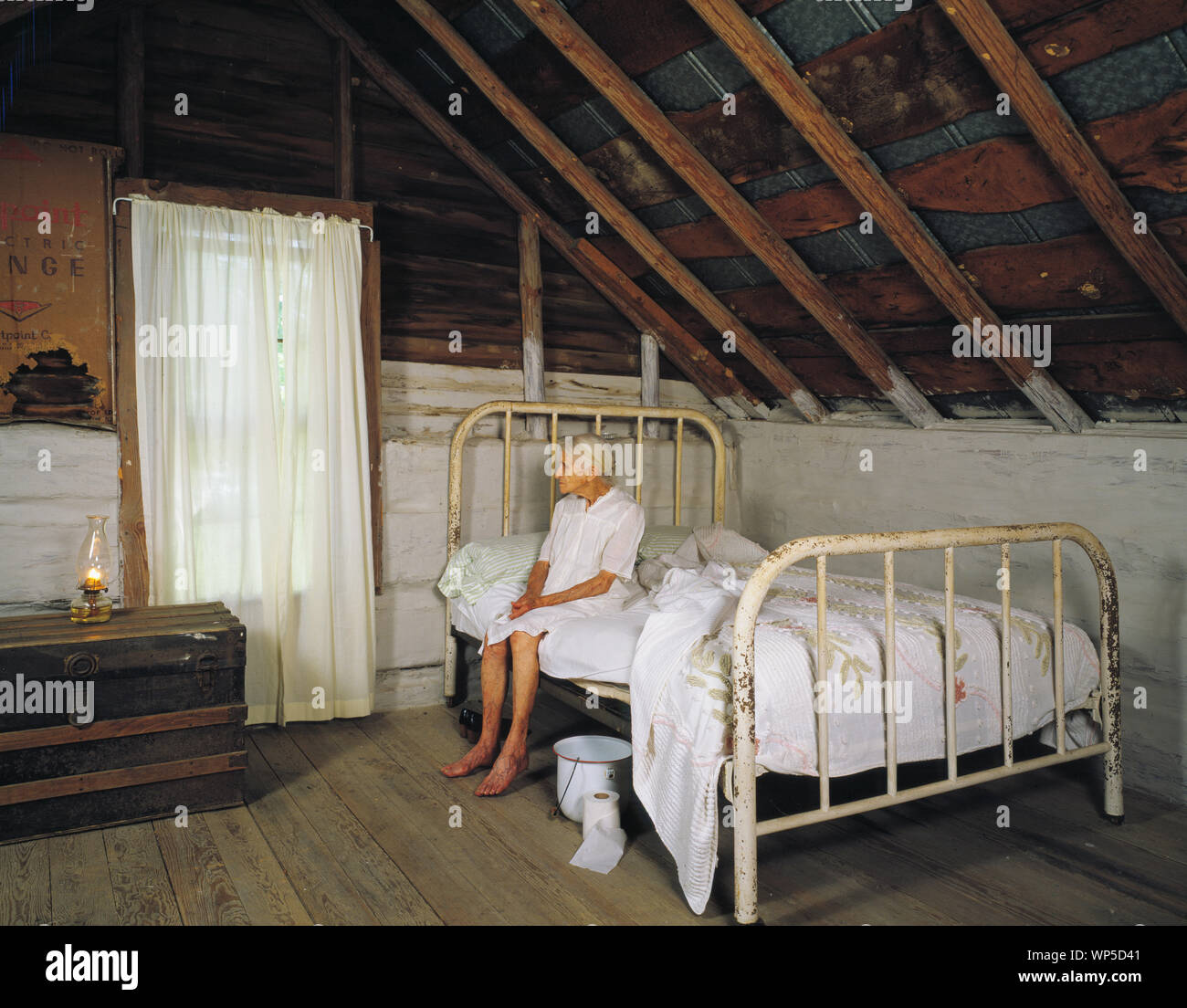 Kate Carter, on her 90th birthday, poses in the log cabins where photographer Carol M. Highsmith's great-grandfather, Pleasant Jiles Carter (1847-1931) and grandfather, Yancey Ligon Carter (1873-1947) were born and lived in Wentworth, North Carolina Stock Photo