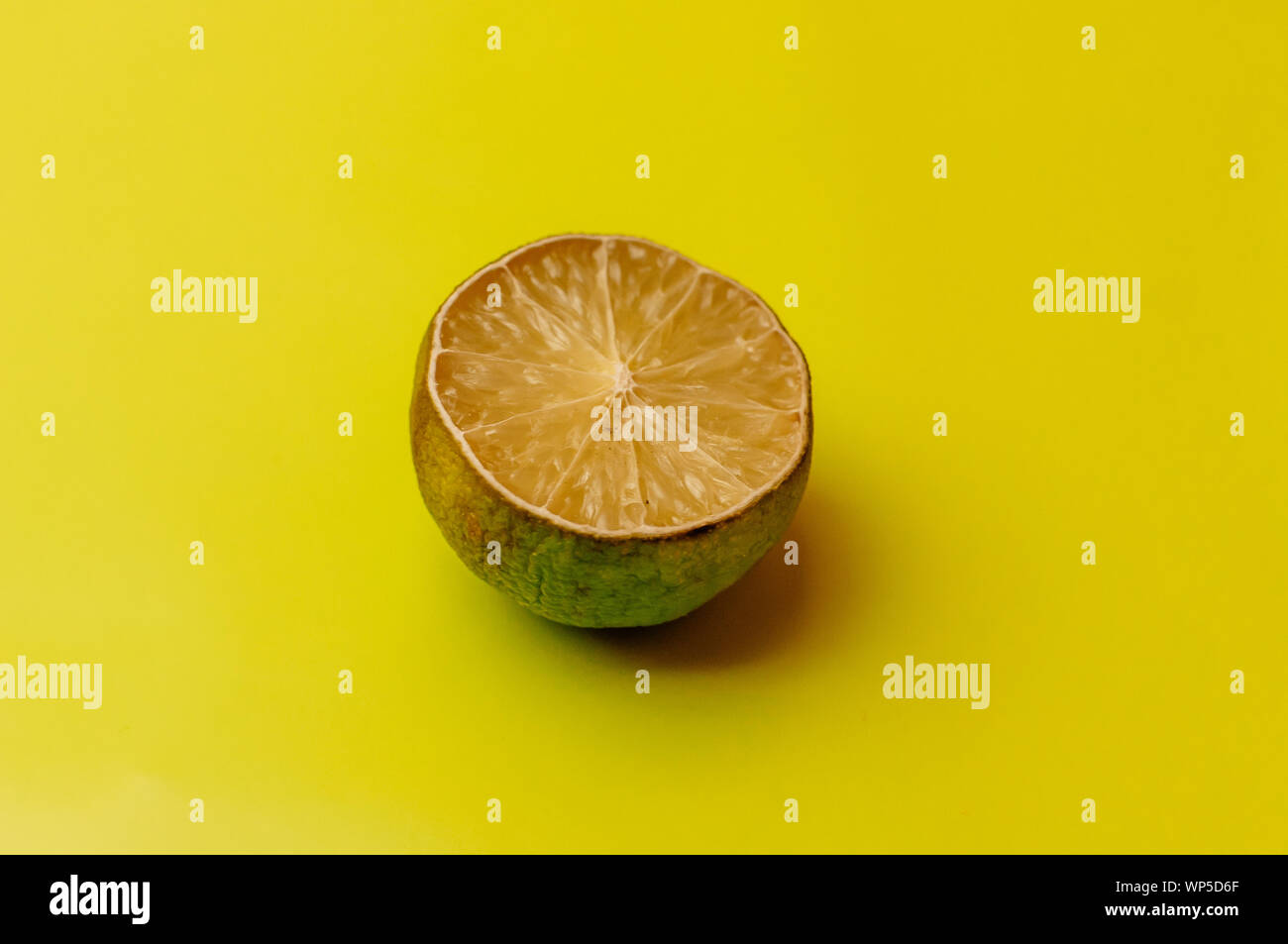 The concept of ugly fruits and citrus fruits. Half of sliced lime has