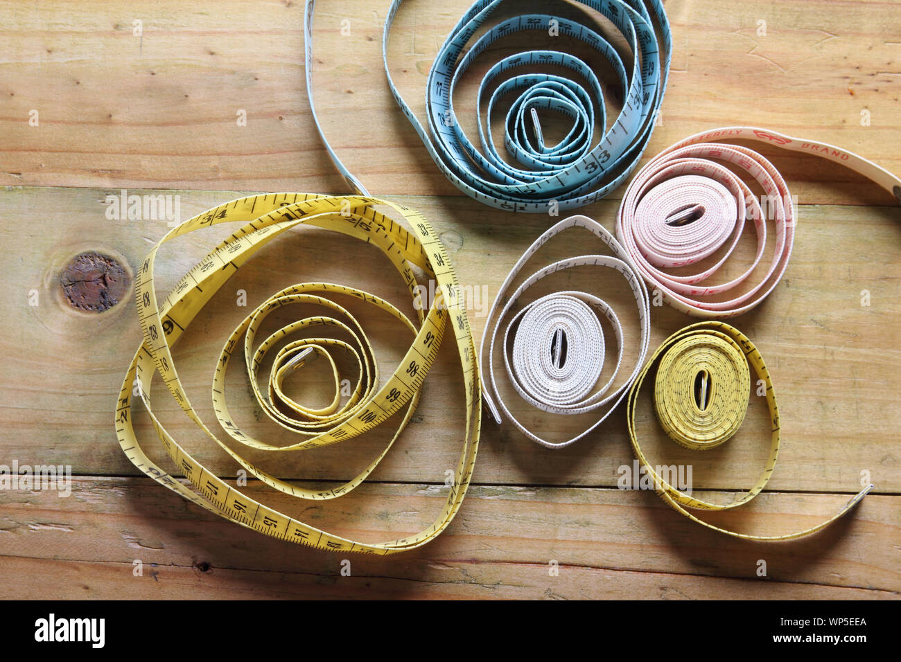 Tape Measures on Wooden Background Stock Photo