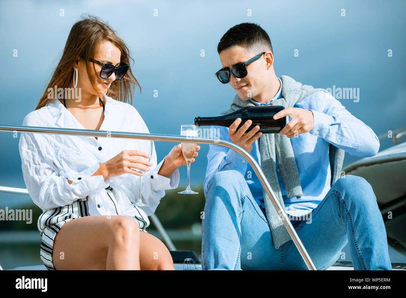 Two young tourists having fun on boat tour in the summertime Stock Photo