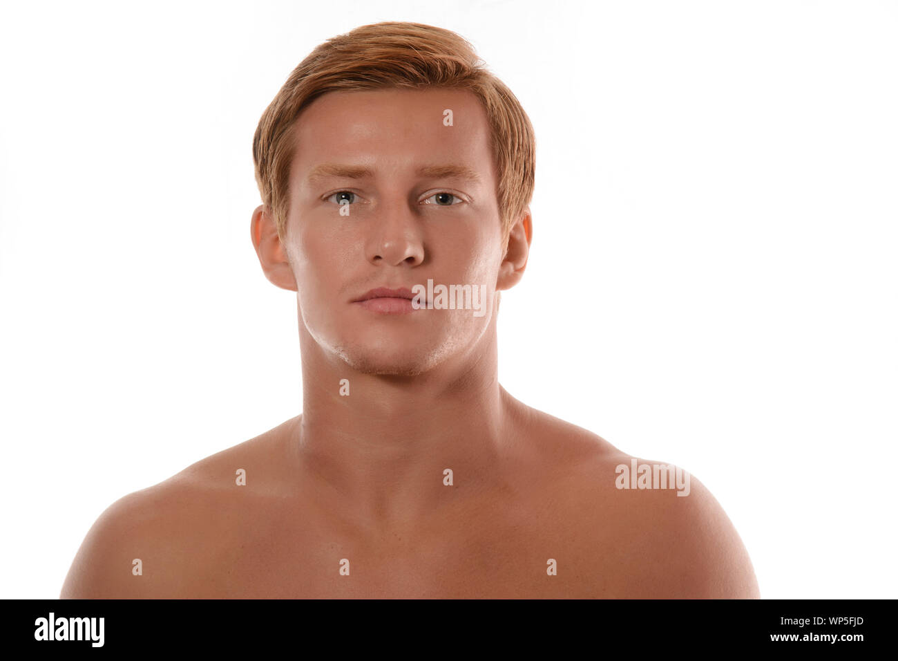 Handsome young man portrait isolated on white background. Muscular teenage guy portrait. Teenager boy face closeup Stock Photo