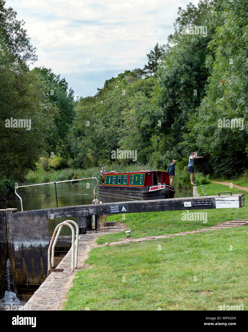 canal Boat approaching a lock on the Kennet and Avon canal just West of Newbury. Stock Photo
