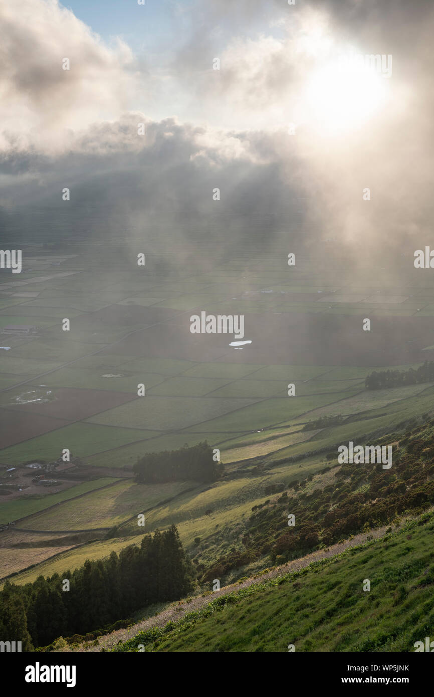 low clouds over the Miradouro da Serra do Cume revealing the typical plots with walls landscape of Terceira, Azores Stock Photo