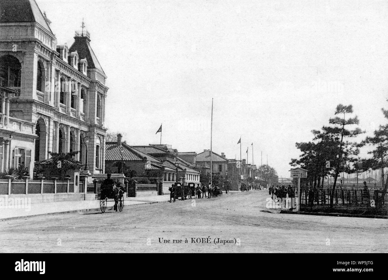 [ 1900s Japan - Kobe Bund ] —   The Bund or Kaigandori in Kobe, Hyogo Prefecture.  The large building on Kaigandori 2 was orginally the office of Walsh Hall & Co, which established a paper mill in Sannomiya. This incidentally grew into the Mitsubishi Paper Mills.  In 1881 (Meiji 14), the building was sold to the Hongkong and Shanghai Bank, now better known as HSBC. The Oriental Hotel, opened on Kaigandori in 1907, has not yet been built.  This postcard is from a series of French cards, photographed sometime between 1902 and 1907.  20th century vintage postcard. Stock Photo