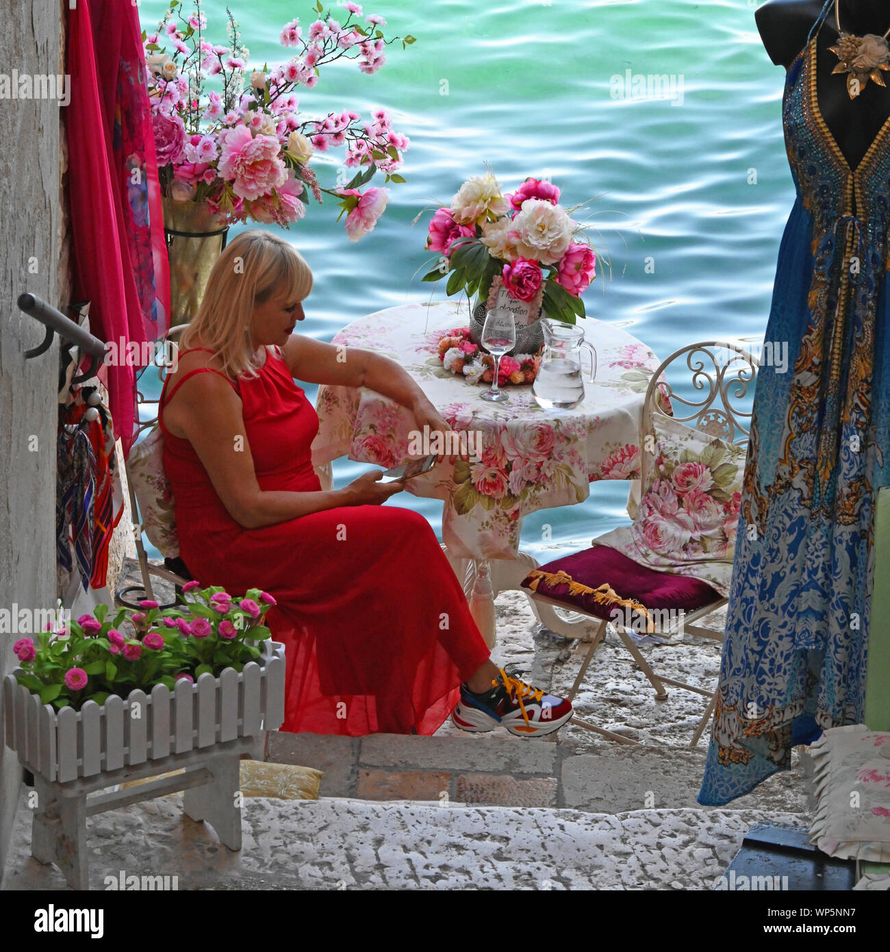 Woman in shop, floral background, Rovinj Old Town, Croatia Stock Photo