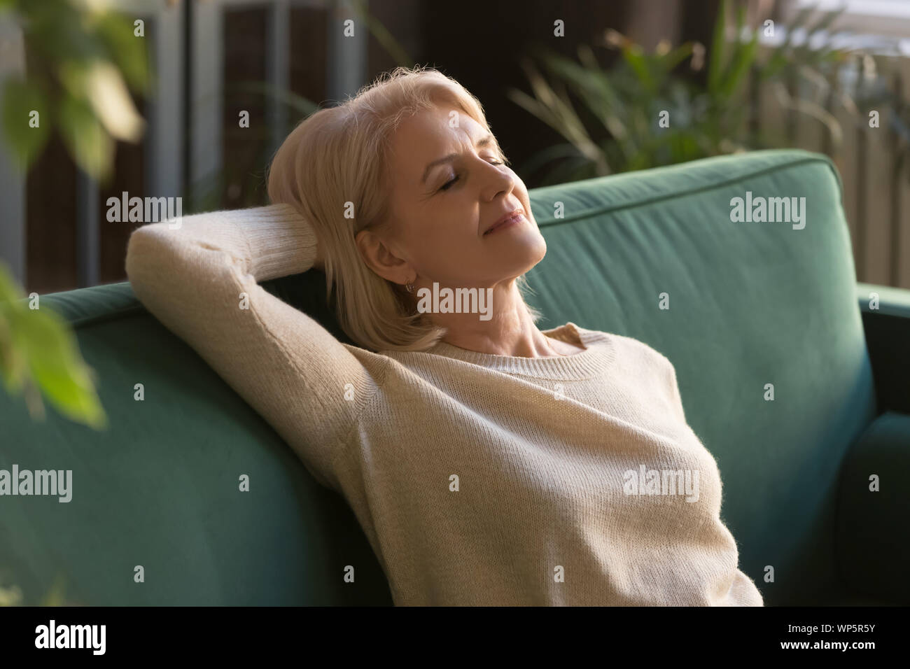 Mature woman with eyes closed hi-res stock photography and images - Alamy