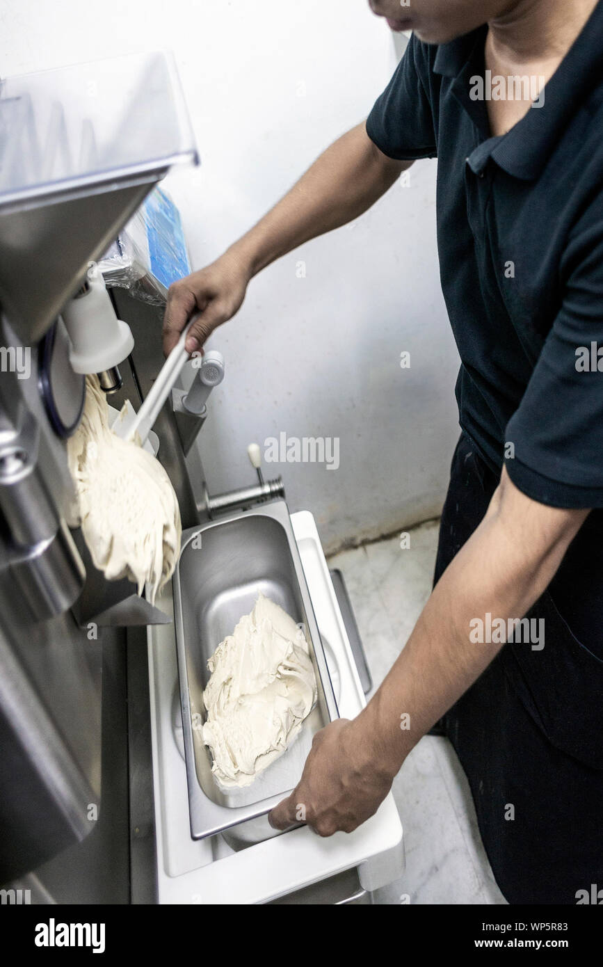 making gelato ice cream with modern professional equipment preparation