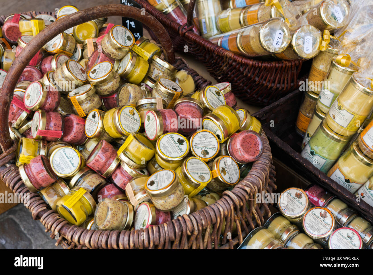 A close up view of many different types of Dijon mustard jars in a