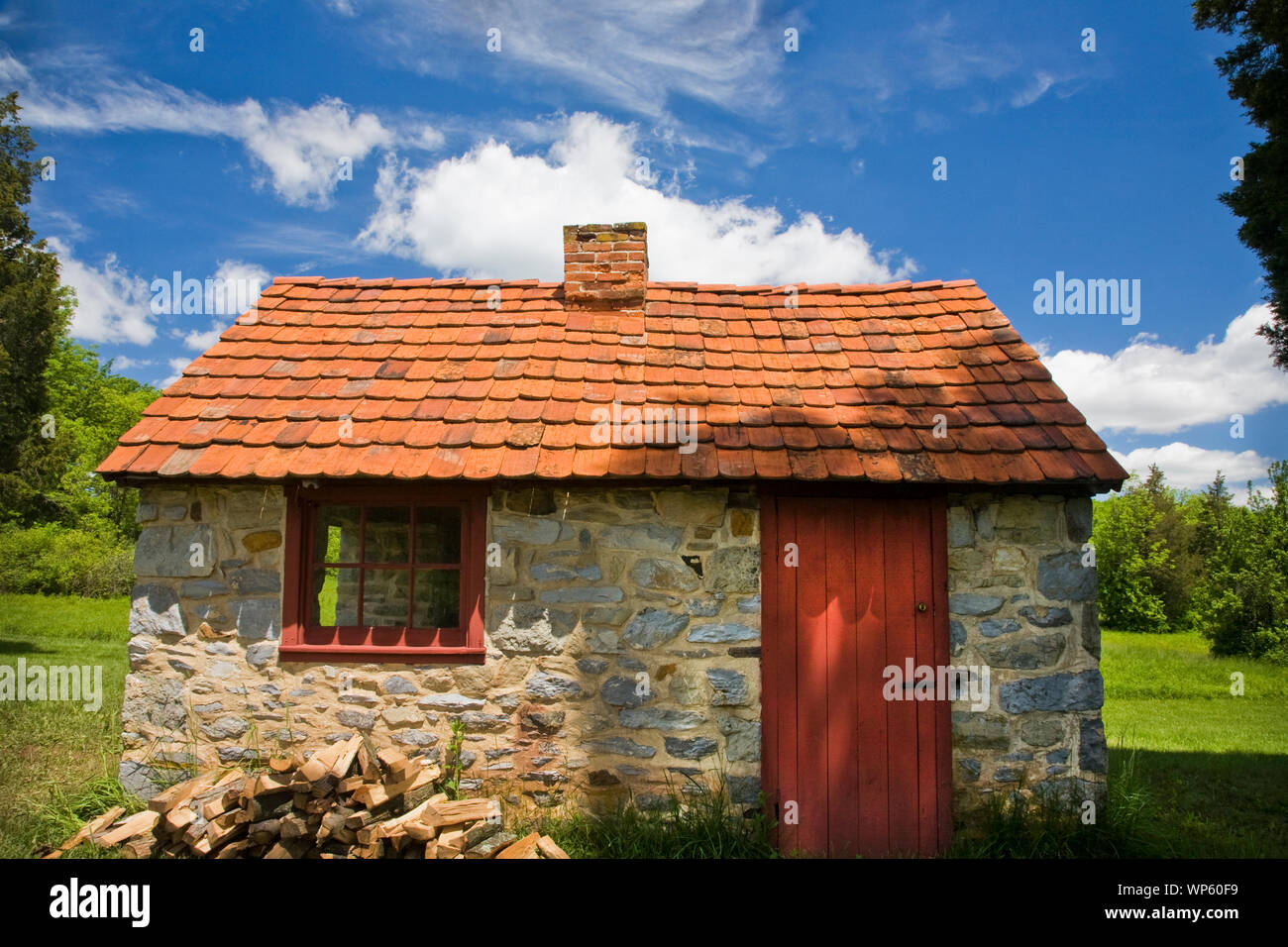 Historic stone Smokehouse with a vintage tile roof at the Daniel Boone Homestead, Berks Co., Pennsylvania, USA, US Birdsboro, Pa images, pioneer Stock Photo