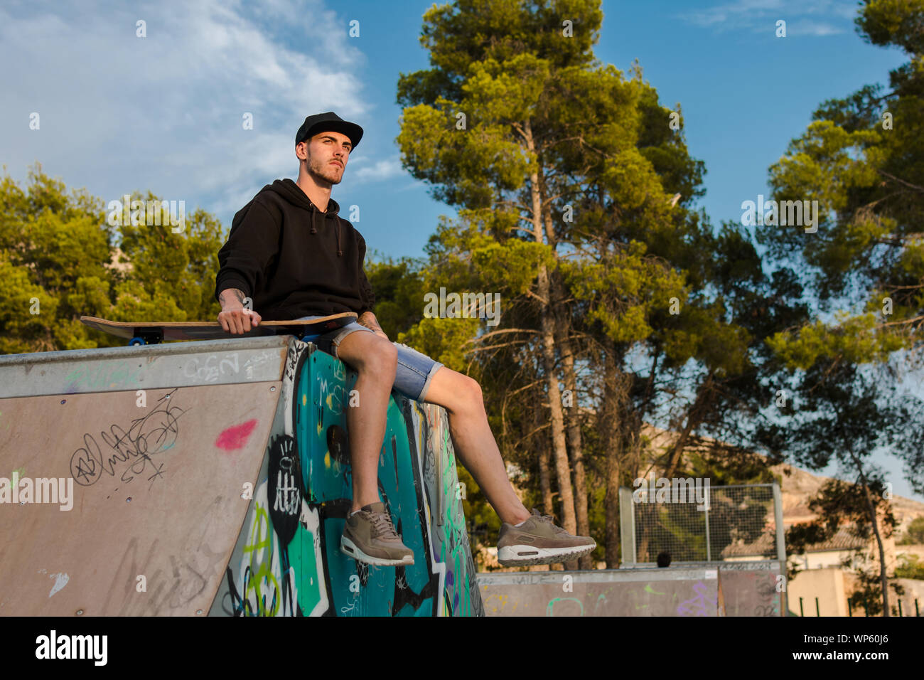 Young man on a skate in a skating court Stock Photo