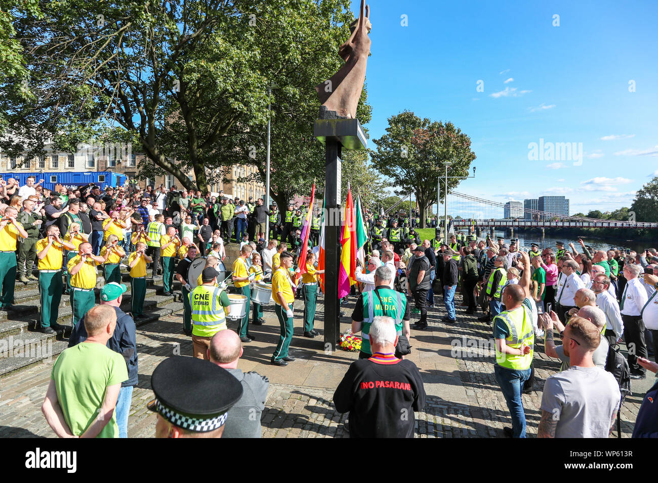 Glasgow, UK 07 September 2019. The Pro-Republican, Pro Irish group, the Calton Republicans marched through Glasgow's east end from Millroad Street to Clyde Street and stopped at the anti fascist statue celebrating the people of Glasgow who fought against Franco in the Spanish civil war. After the recent and significant street disturbances in Govan between sectarian groups there was a heavy police presence to prevent any disorder. Credit: Findlay/Alamy News Stock Photo