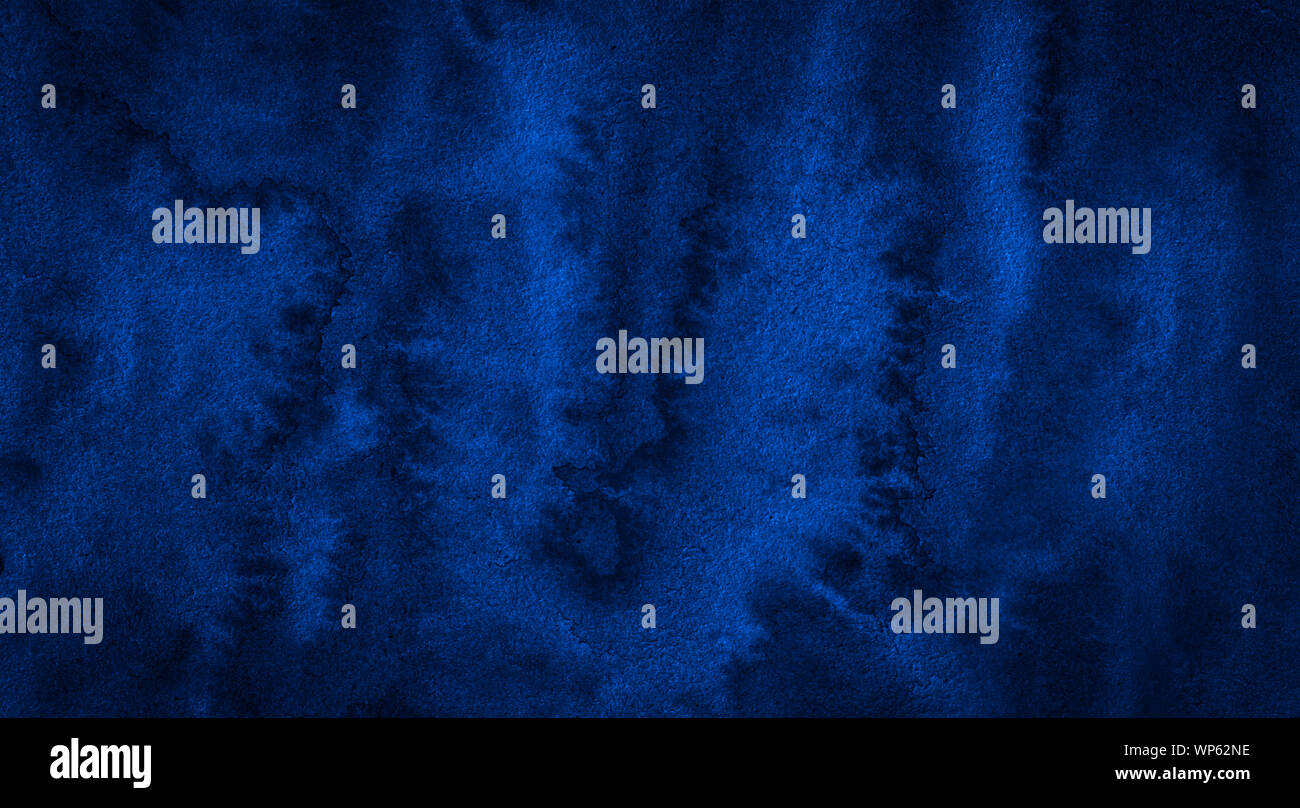 Dark rich blue watercolor background with torn strokes and uneven ...