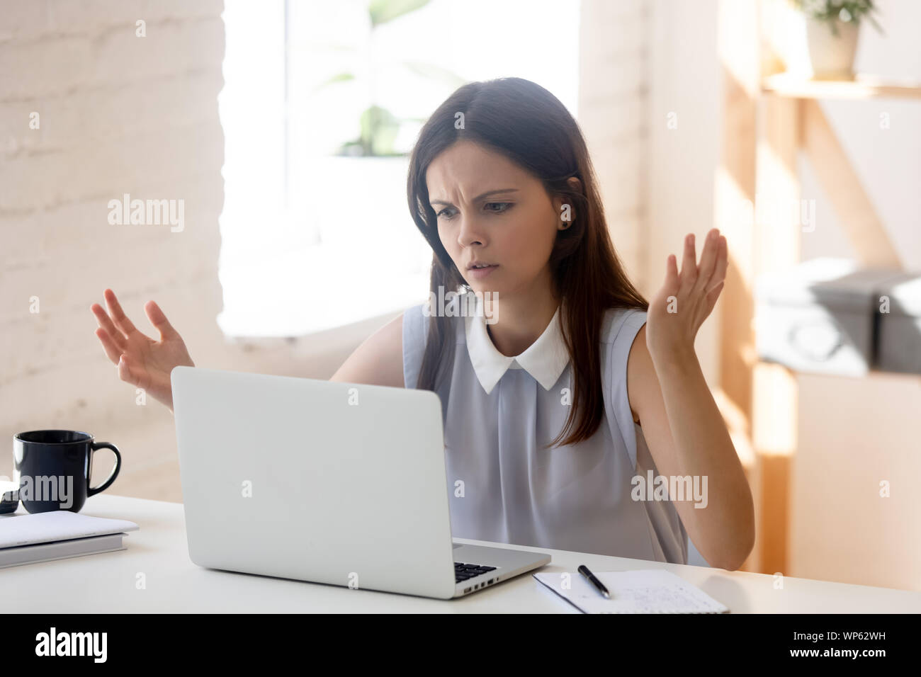 Confused girl feel frustrated having computer problems working Stock Photo