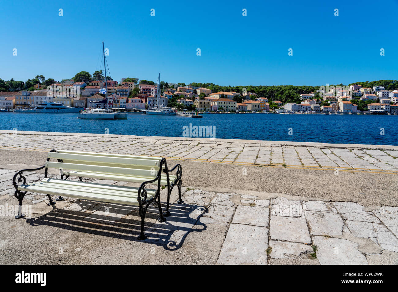 bench in the harbor of mali losinj island port croatia Stock Photo