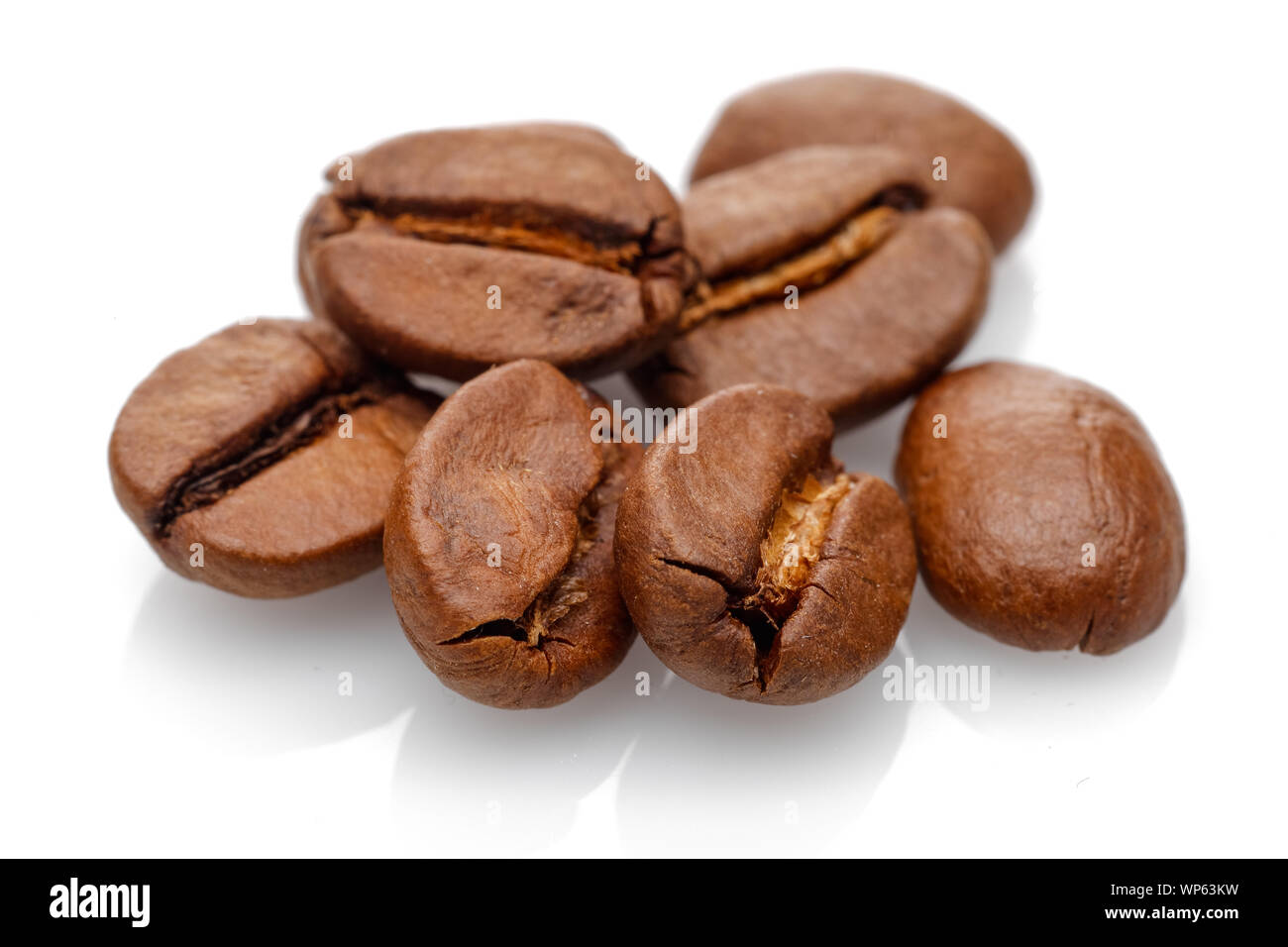Heap of roasted coffee beans isolated on white background Stock Photo ...