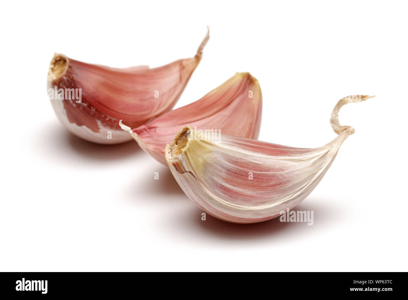 Three garlic cloves isolated on white background Stock Photo