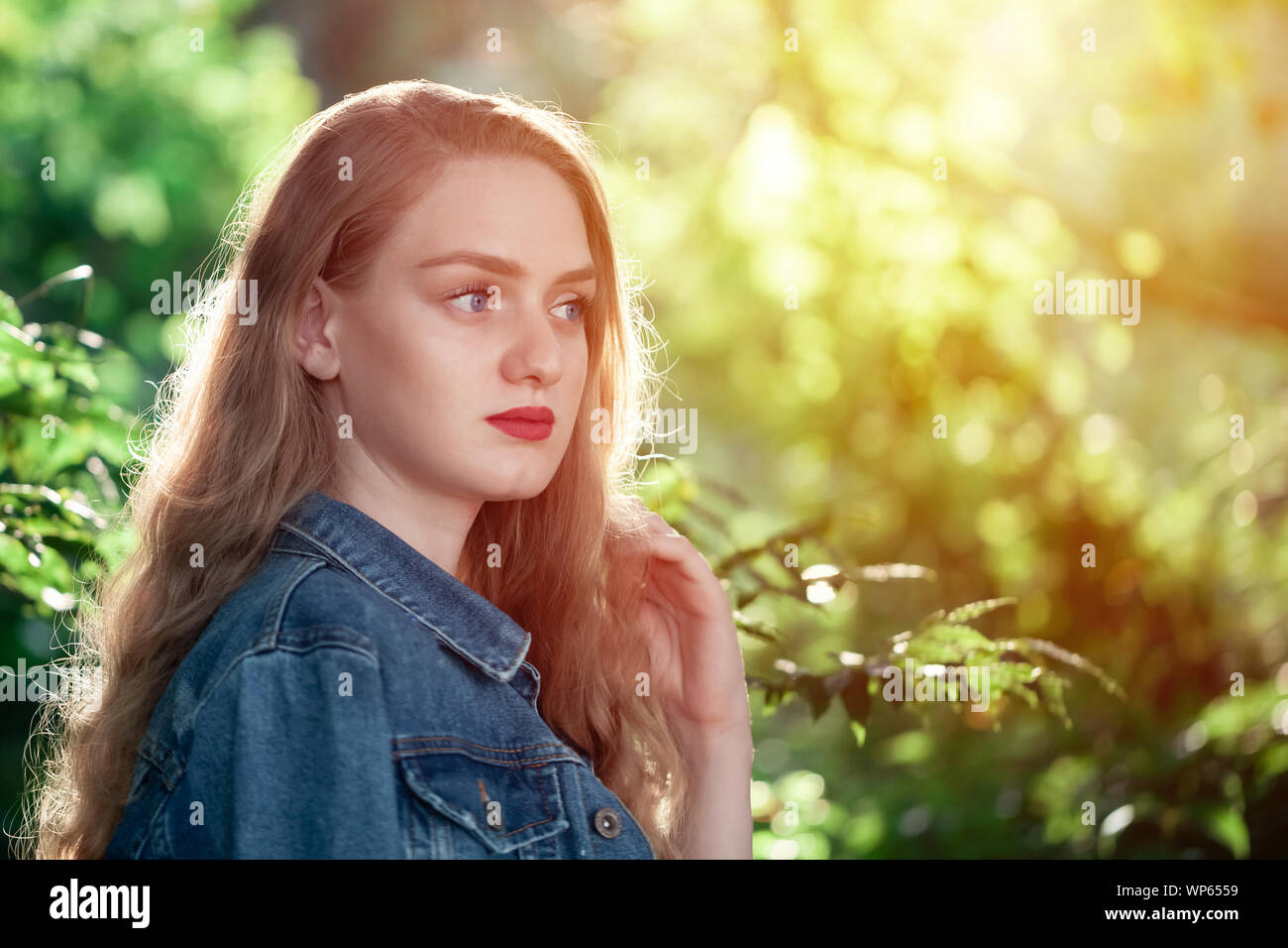 Beautiful blue eyed blonde girl in the parkPortrait. Stock Photo