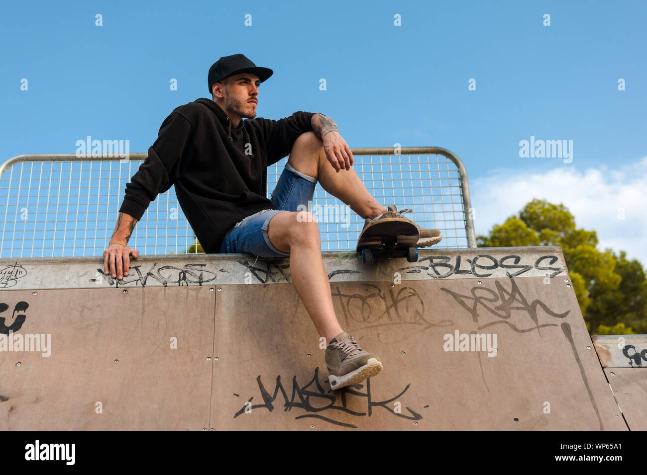 Young man on a skate in a skating court Stock Photo