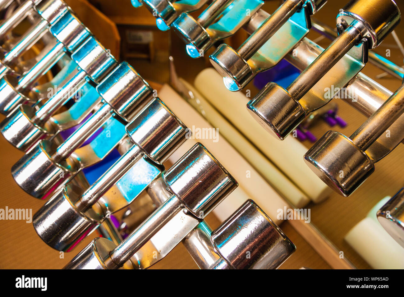 Rows of chrome plated dumbells at a gym. Stock Photo