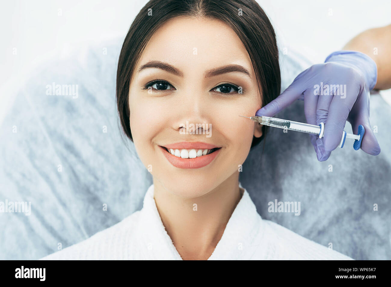 asian woman getting rejuvenation injection for fresh skin. Staying