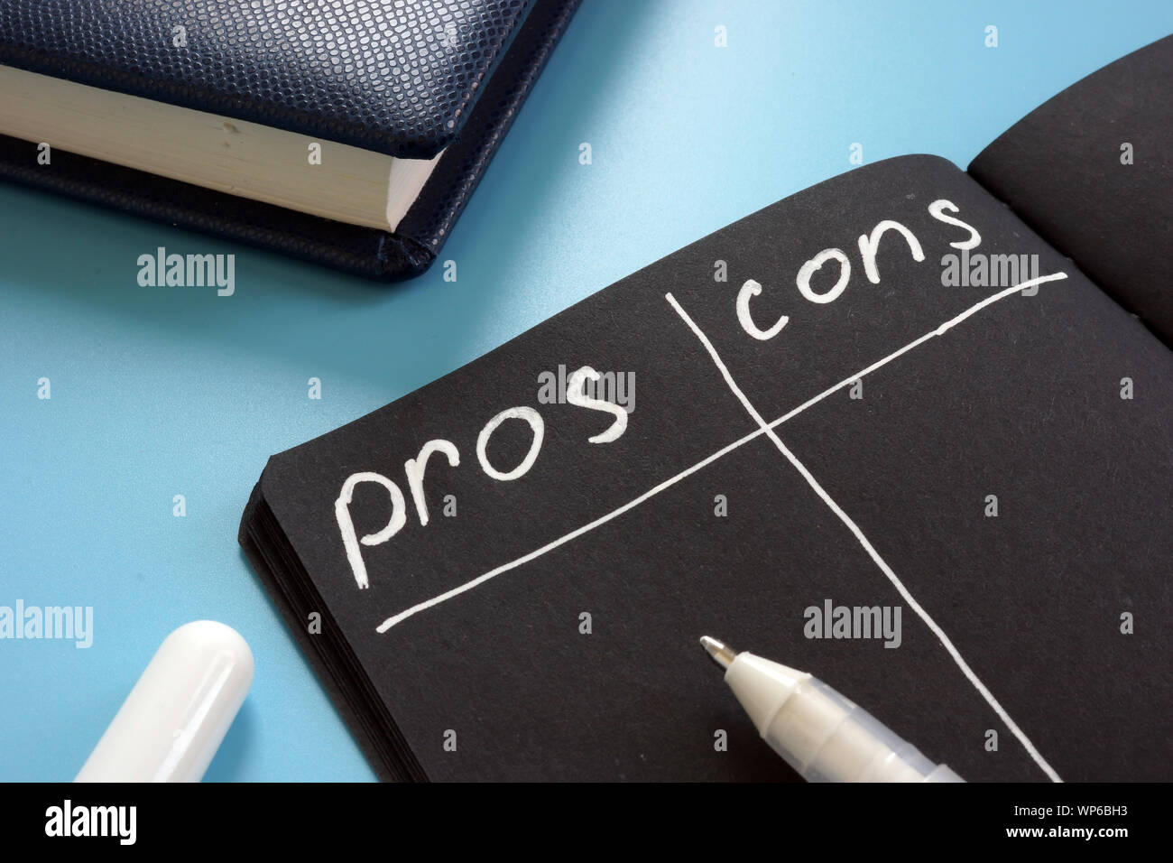 Pros and Cons list on the black page Stock Photo Alamy