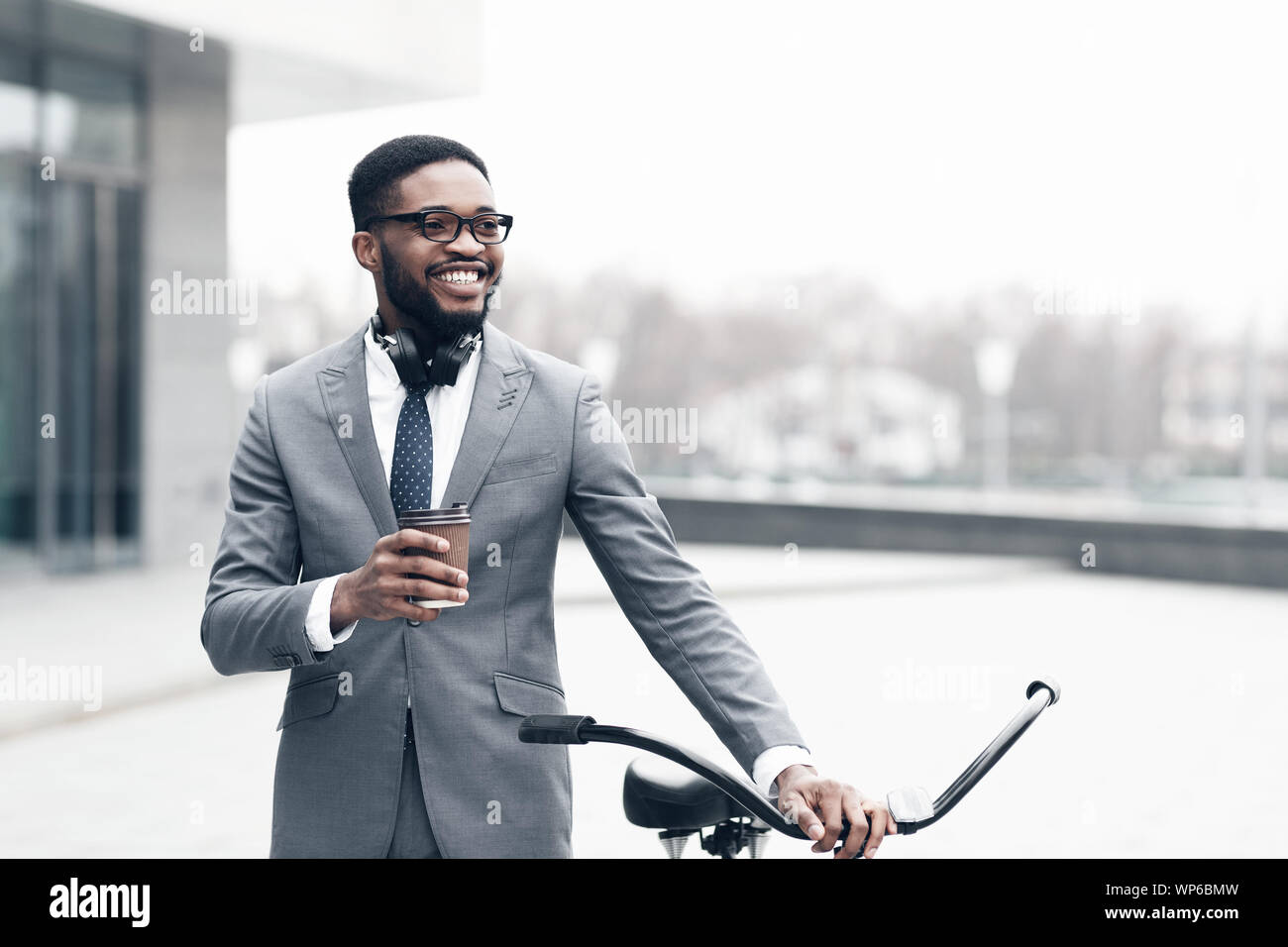 Young happy businessman going to work by bike Stock Photo Alamy