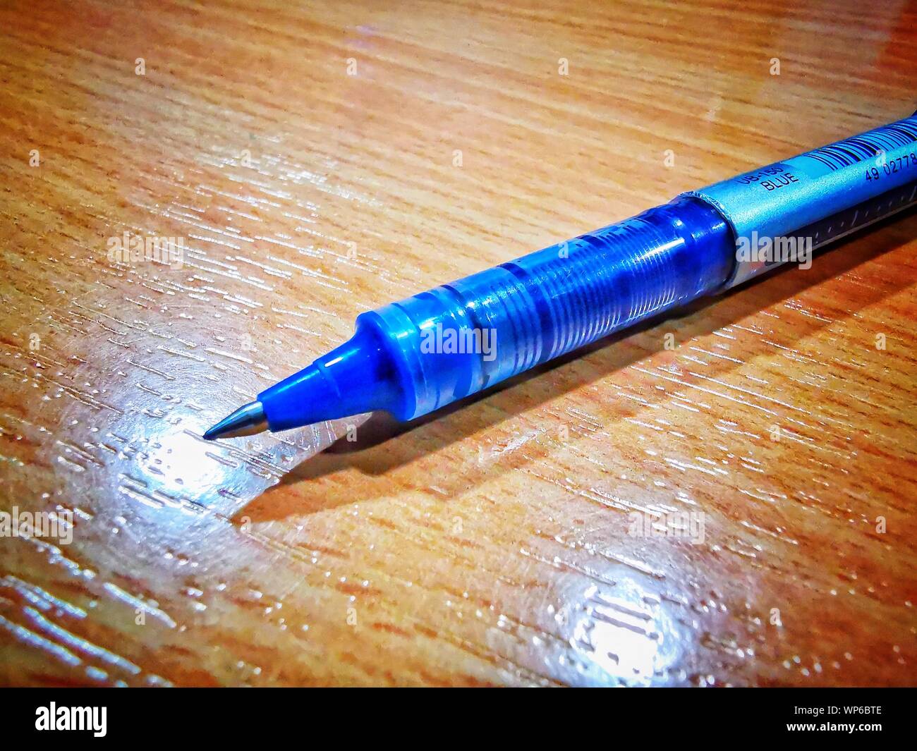 blue ball pen macro detailed image placed on a desk table Stock Photo
