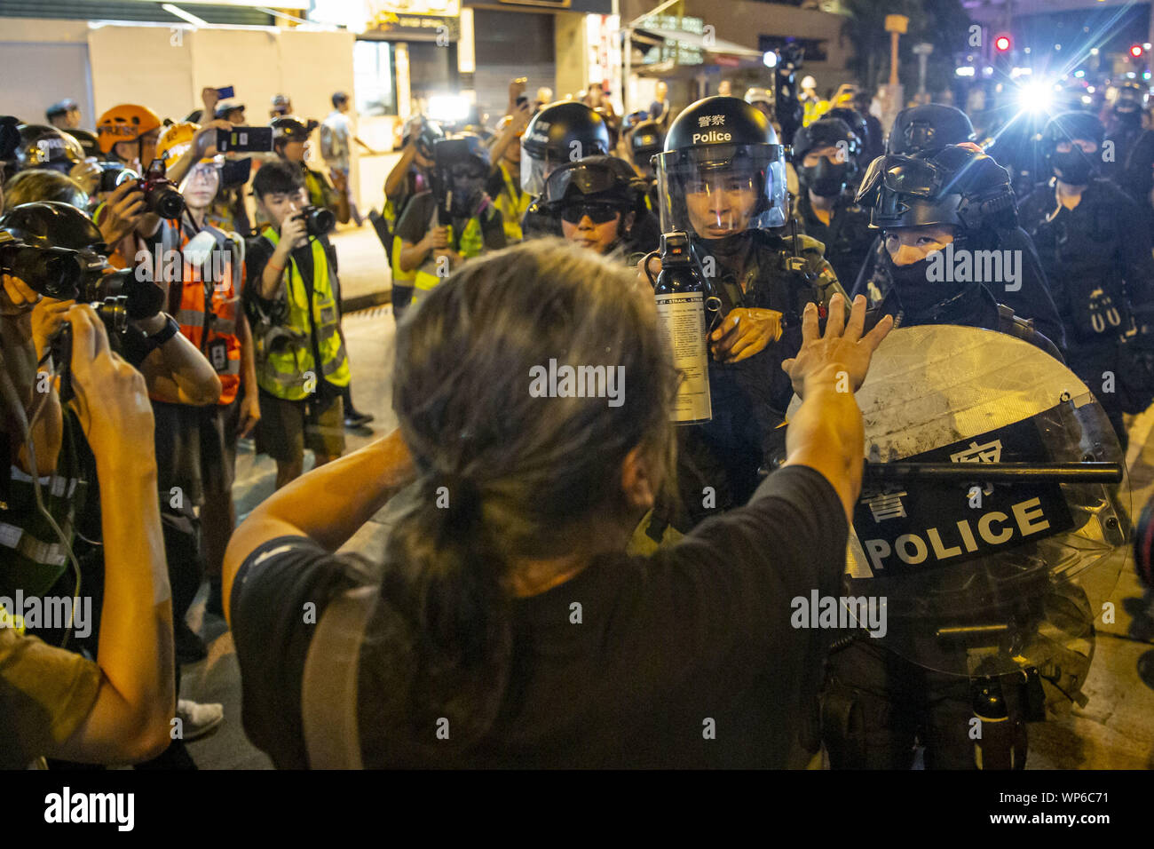 Hong Kong, China. 7th Sep, 2019. A pro democracy protester implores police to show restraint as he walks towards them and an officer points a can of pepper spray in his face. Hundred of protesters and members of the publicgathered for yet another night in front of the Mongkok police station in order to continue demanding the release of the cctv footage from the Prince Edward MTR station, the site of an alleged brutal police crackdown on suspected protesters and members of the public. Credit: Adryel Talamantes/ZUMA Wire/Alamy Live News Stock Photo