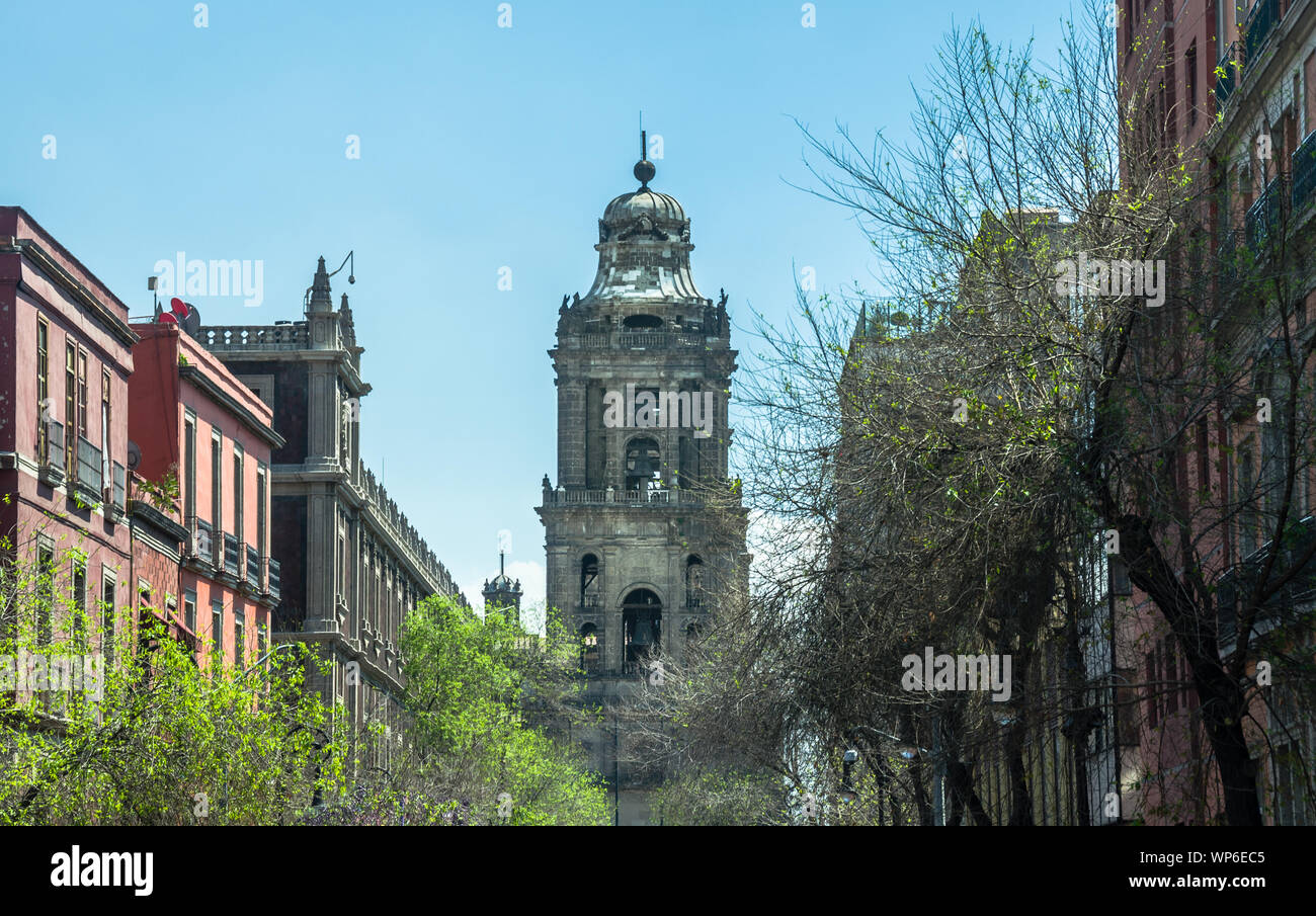MEXICO CITY, MEXICO / MARCH 2 2019: La Catedral Bell Tower viewed from 5 de Mayo street, Metropolitan Cathedral of the Assumption of Mary of Mexico Ci Stock Photo