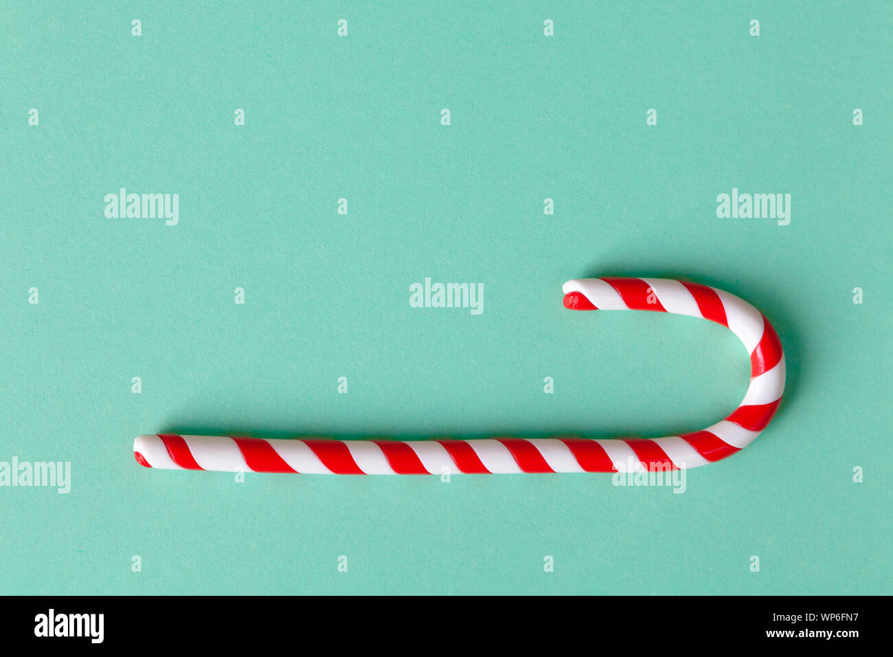 Christmas peppermint candy cane on pastel turquoise background. Festive ...