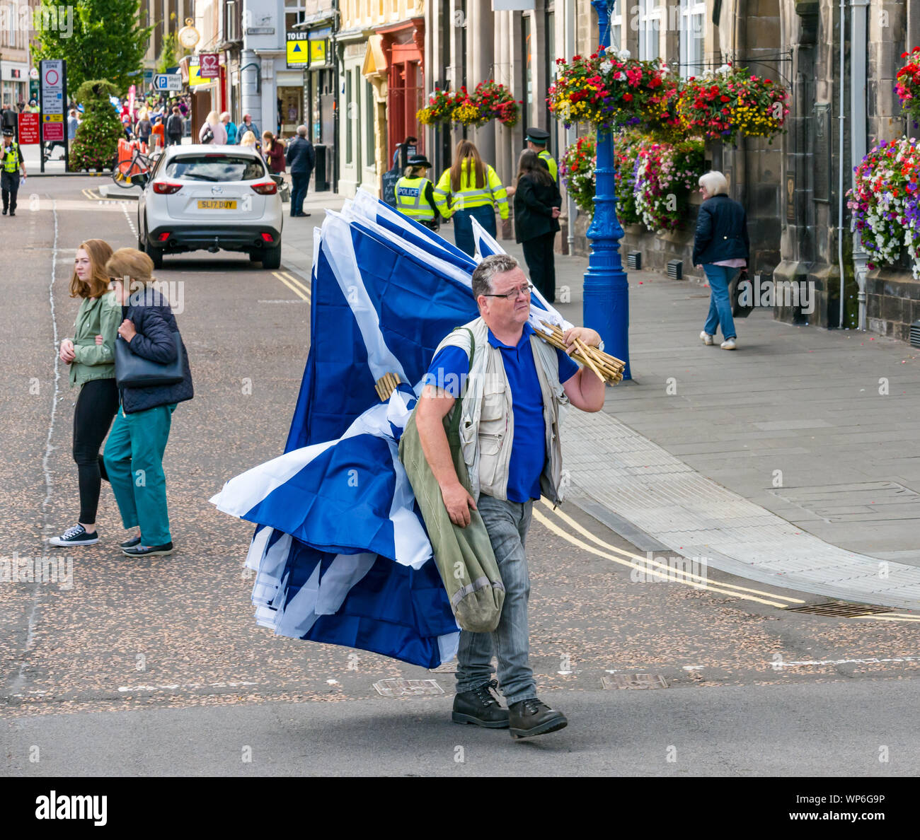 Perth, Scotland, United Kingdom, 7th September 2019. All Under One Banner Independence March: Independence supporters march through Perth in the 7th All Under One Banner (AUOB) march of this year. A saltire flag seller (flags £5 each) Stock Photo