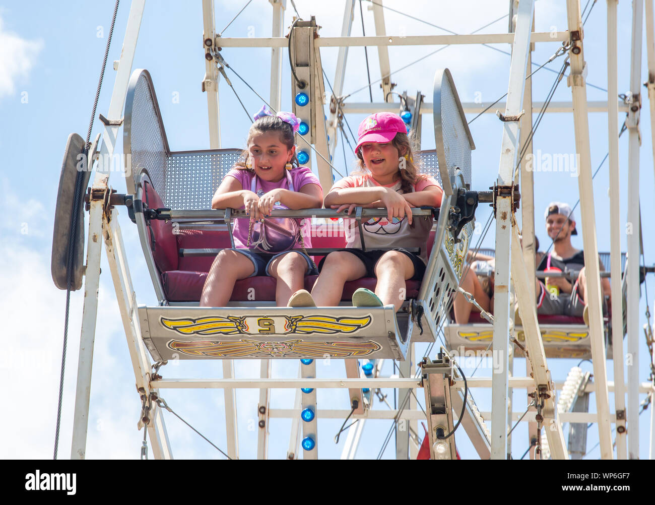 MATTHEWS, NC (USA) - September 2, 2019: Closeup of children enjoying a ferris wheel ride at the annual 'Matthews Alive' community festival. Stock Photo