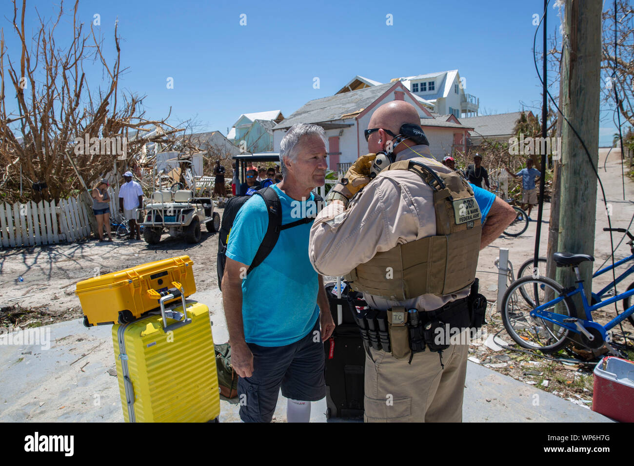 Marsh Harbour, Abaco, Bahamas. 05 September, 2019. A U.S. Customs and Border Protection officer assists a member of the search and rescue team on the ground in Hope Town in the aftermath of Hurricane Dorian September 5, 2019 in Marsh Harbour, Abaco, Bahamas. Dorian struck the small island nation as a Category 5 storm with winds of 185 mph. Stock Photo