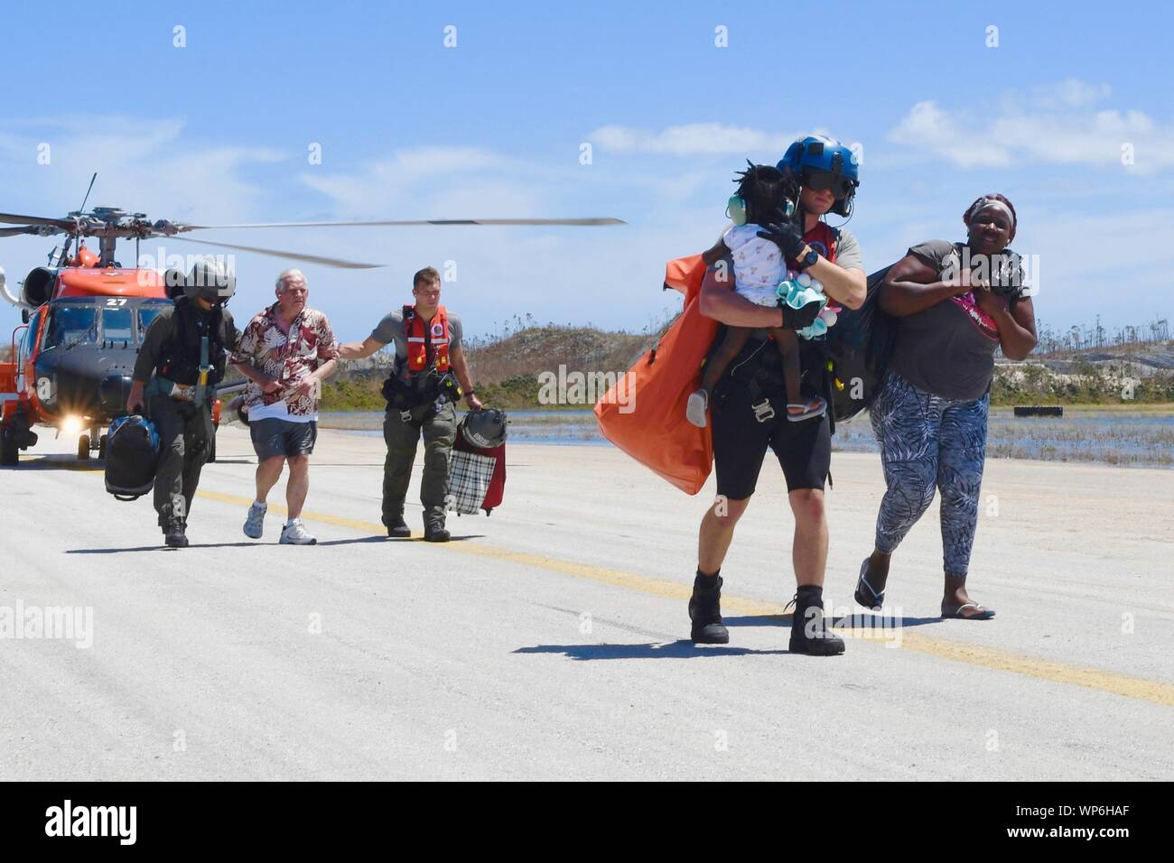 Marsh Harbour, Abaco, Bahamas. 07 September, 2019. U.S. Coast Guard members assist in evacuating survivors in the aftermath of Hurricane Dorian September 7, 2019 in Marsh Harbour, Abaco, Bahamas. Dorian struck the small island nation as a Category 5 storm with winds of 185 mph. Stock Photo