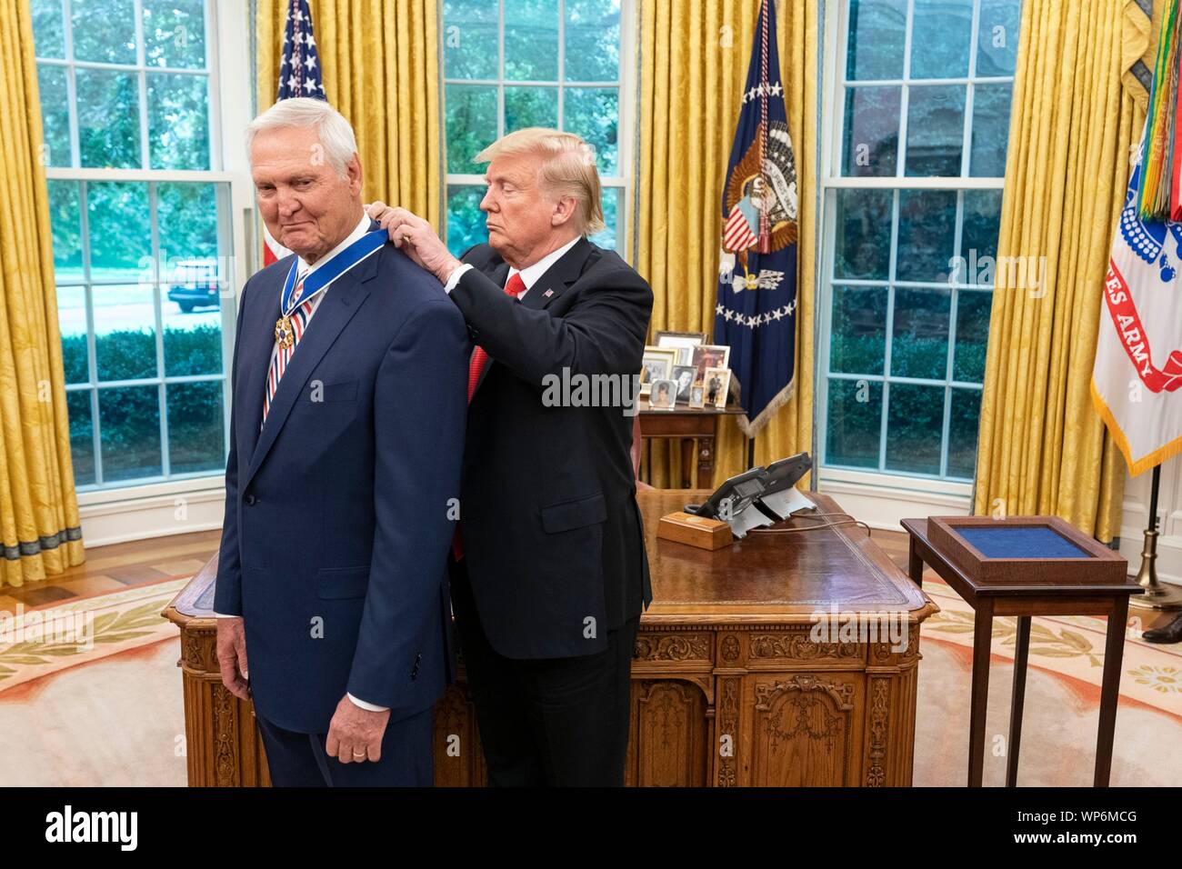 Washington, DC, USA. 05 September, 2019. U.S President Donald Trump, right, presents the Presidential Medal of Freedom, to Hall of Fame Los Angeles Lakers basketball star and legendary NBA General Manager Jerry West during a ceremony in the Oval Office of the White House September 5, 2019 in Washington, DC. Stock Photo