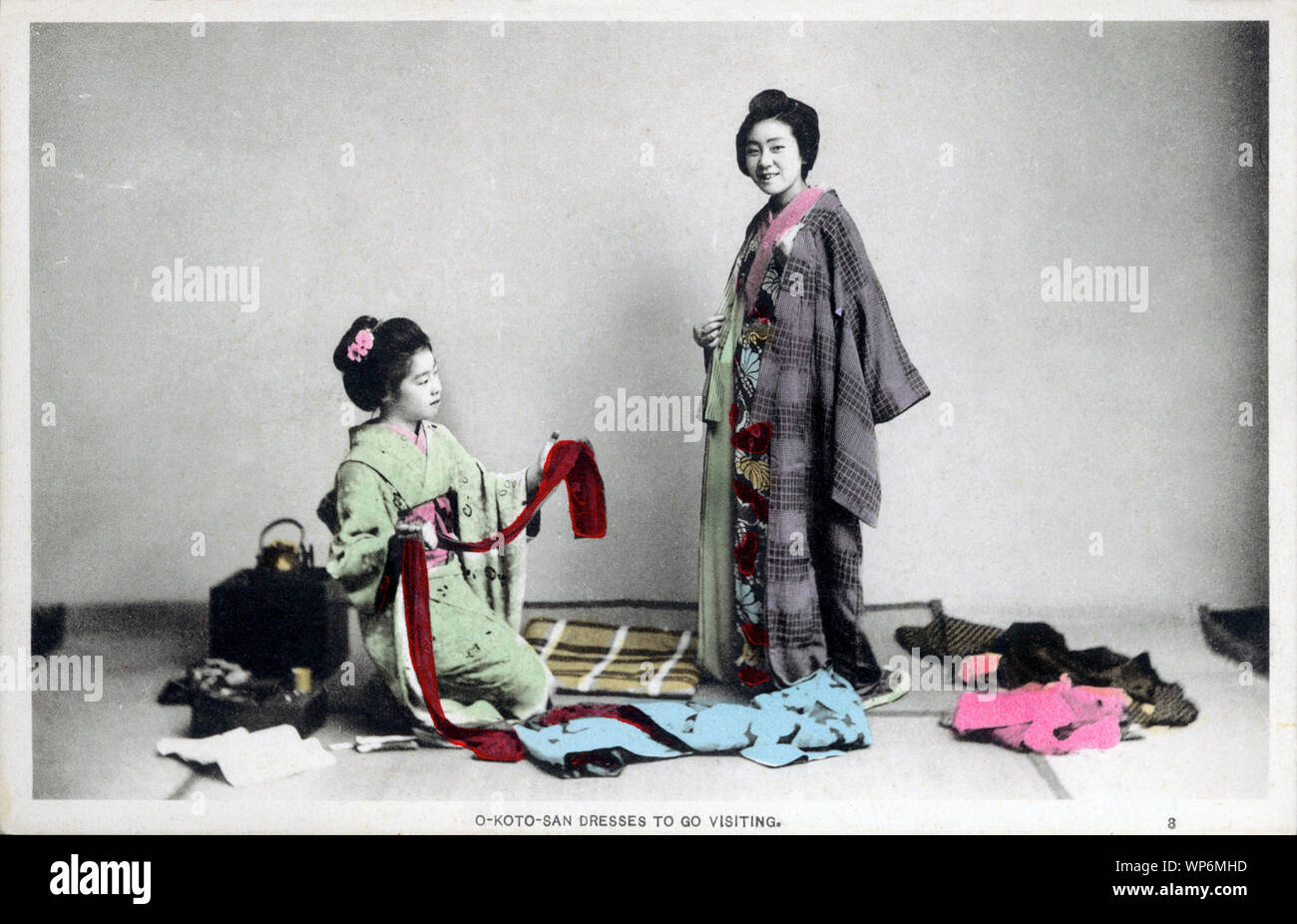 [ 1900s Japan - Japanese Woman Dressing ] —   A day in the life of a young Japanese woman during the Meiji and Taisho Periods in the early 20th century:  3. O-KOTO-SAN DRESSES TO GO VISITING.  20th century vintage postcard. Stock Photo