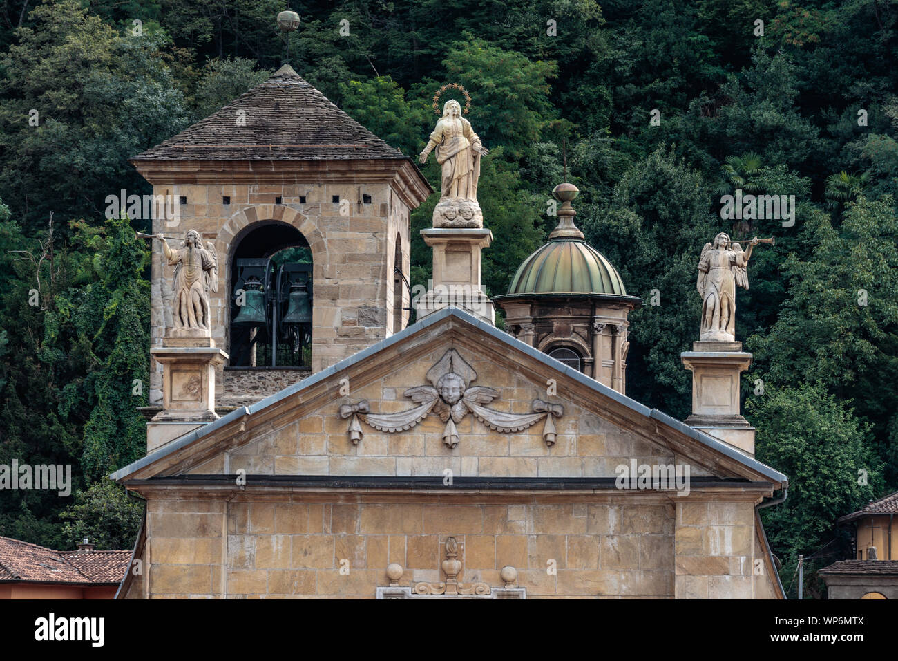 The "Chiesa collegiata dei Santi Pietro e Stefano", a historical Church in Bellinzona, Ticino, Switzerland, with the bell tower and decorative statues Stock Photo
