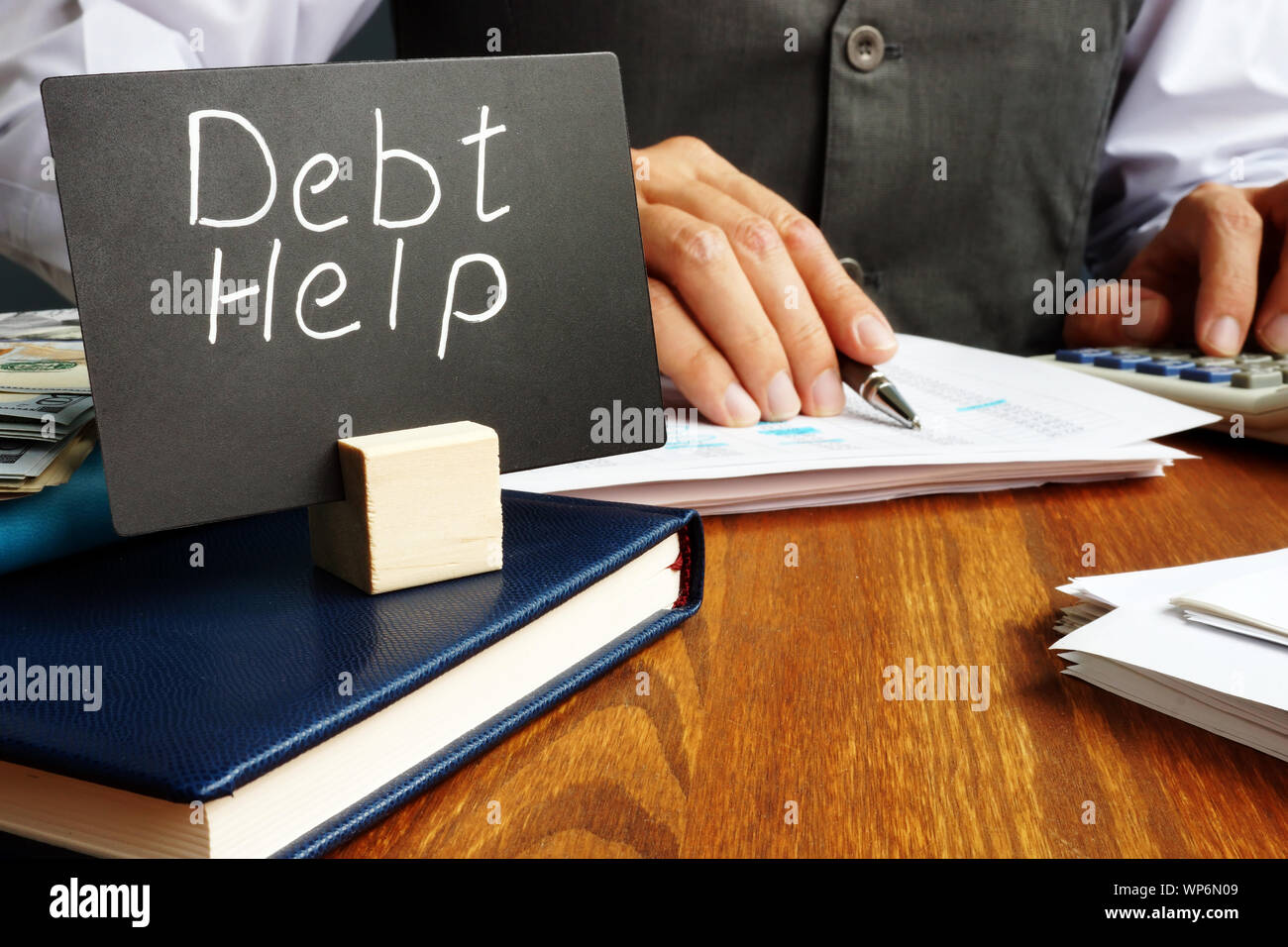 Debt help sign and working man in the office. Stock Photo