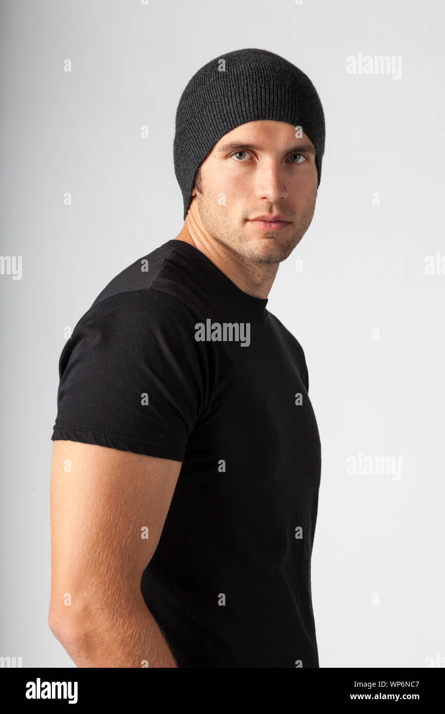 Man wearing black t-shirt and knit hat. Young men's modern casual clothing fashions styles. Stock Photo
