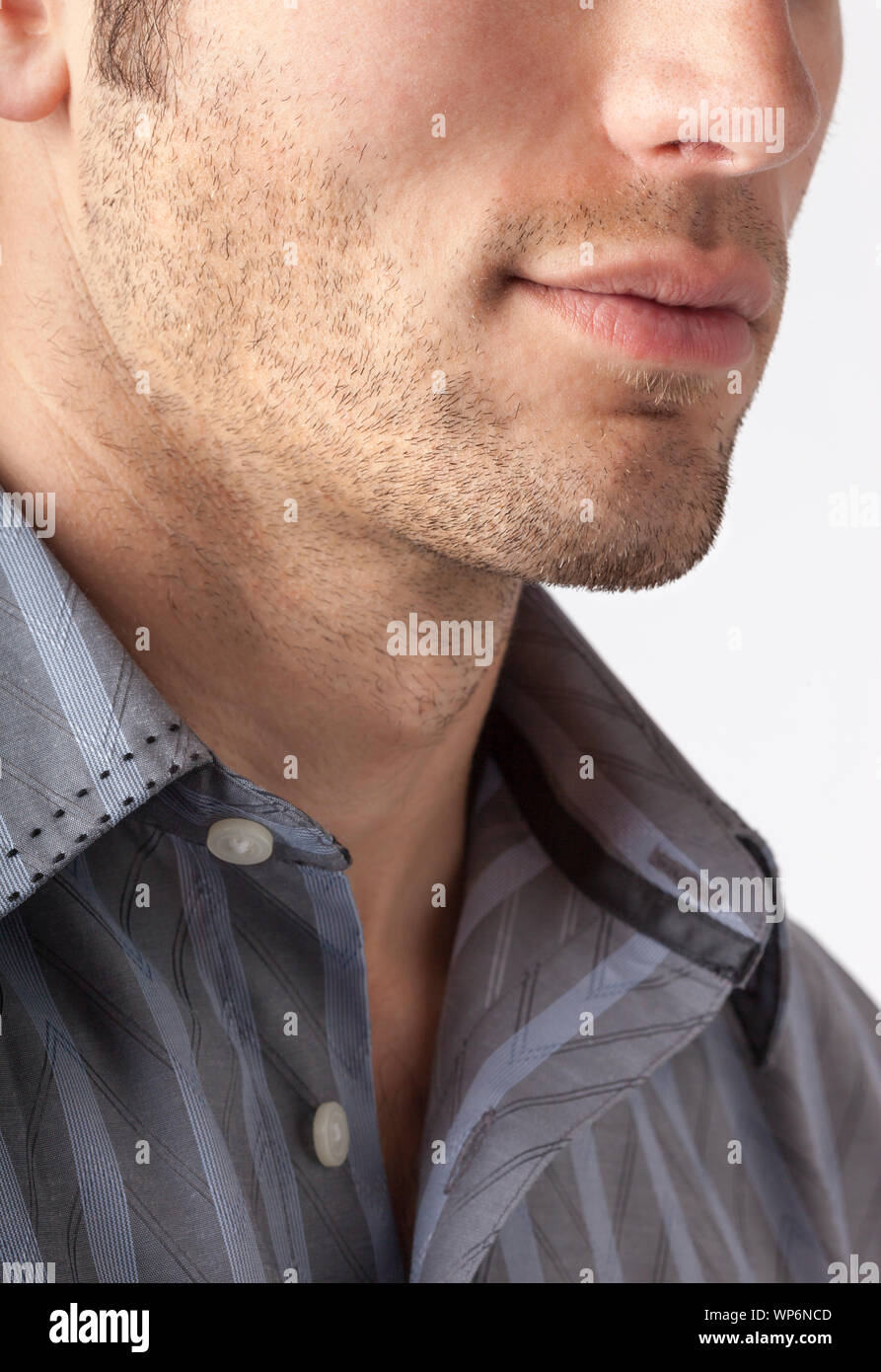 Close-up of man's chin and jawline with facial hair beard stubble five o'clock shadow. Men's personal care and grooming. Stock Photo