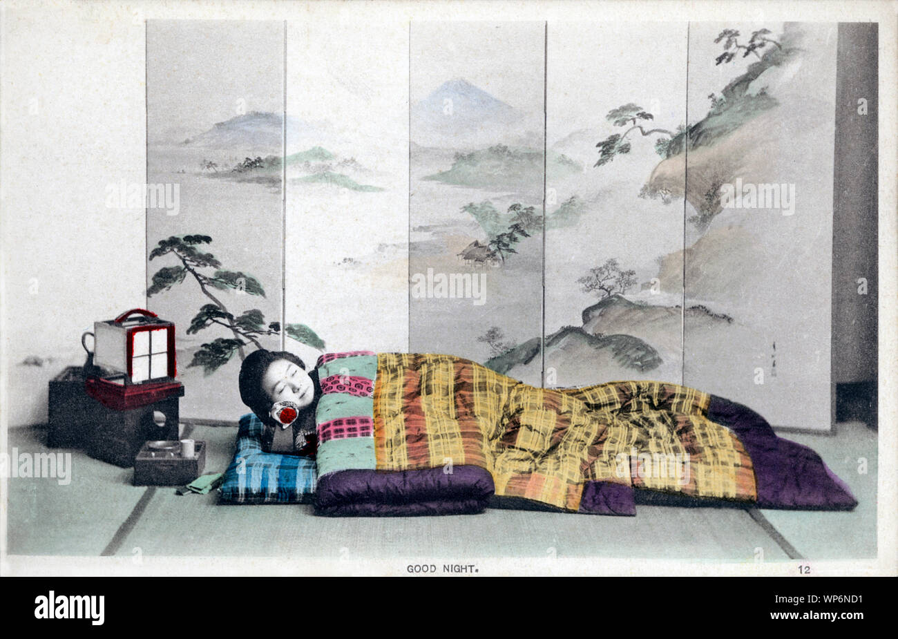 [ 1900s Japan - Japanese Woman Sleeping ] —   A day in the life of a young Japanese woman during the Meiji and Taisho Periods in the early 20th century:  12. GOOD NIGHT.  20th century vintage postcard. Stock Photo