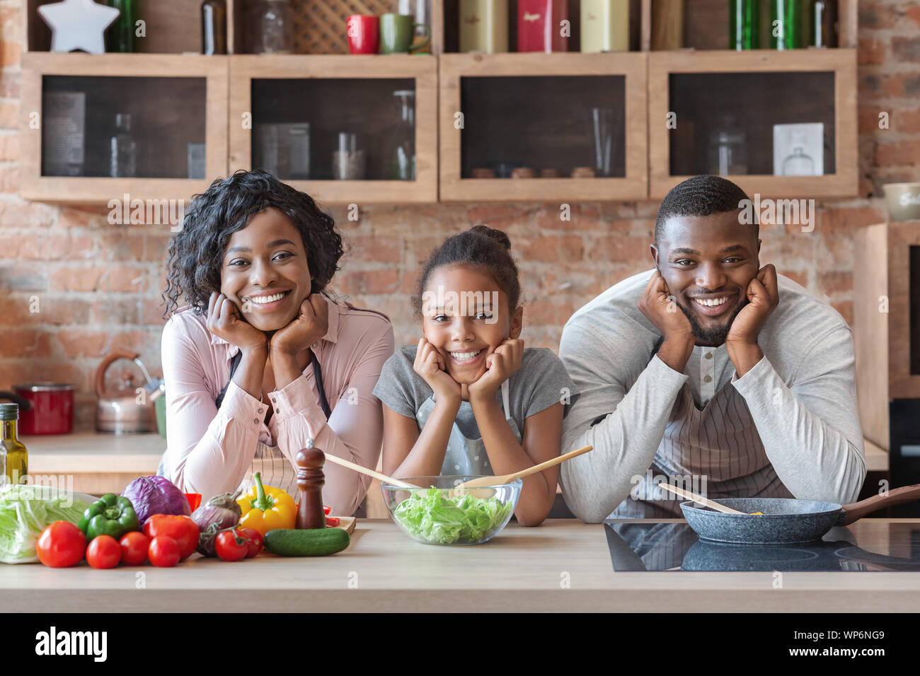 Beautiful african american family making dinner together Stock Photo
