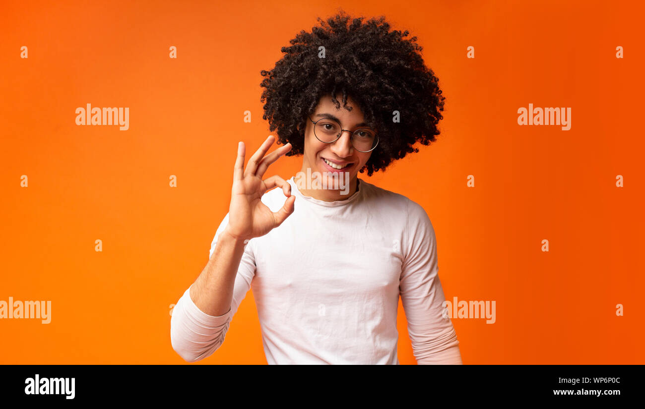 Happy Black Guy Gesturing Okay Sign And Smiling Stock Photo
