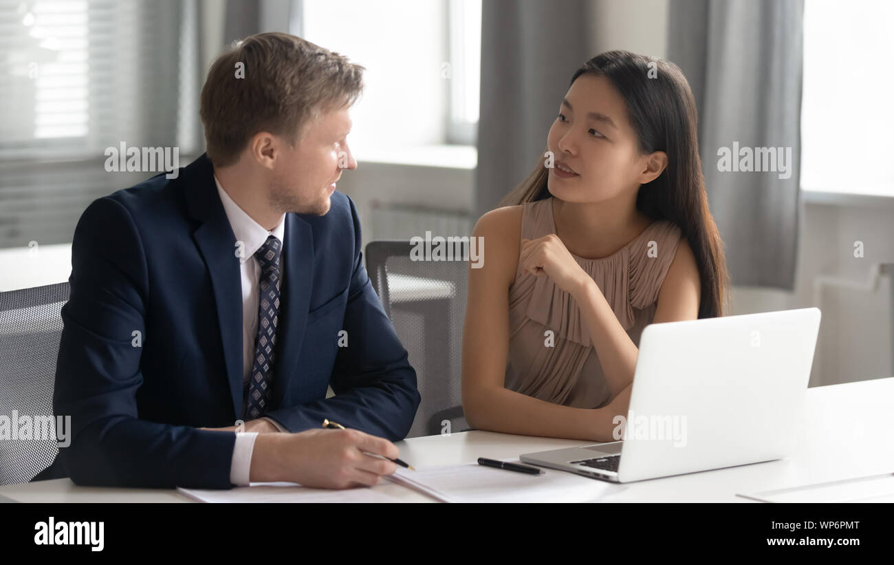 Diverse businesspeople discussing project ideas at office. Stock Photo