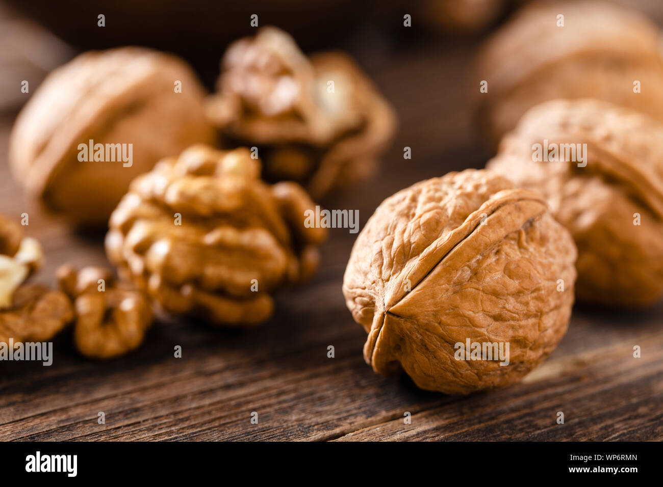 Walnuts. Kernels and whole nuts on wooden rustic table Stock Photo