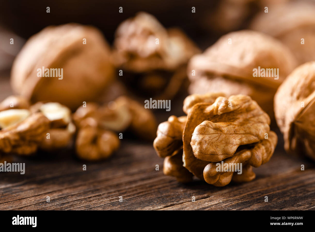 Walnuts. Kernels and whole nuts on wooden rustic table Stock Photo