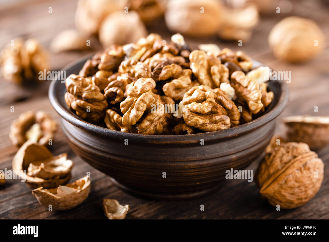 Walnuts. Kernels and whole nuts on wooden rustic table Stock Photo