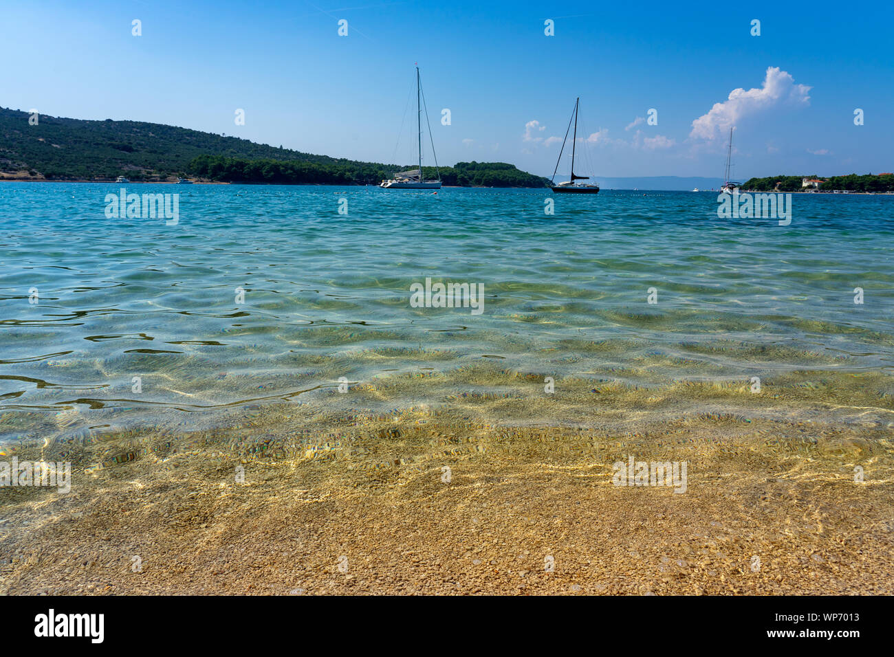 Crystal clear turquoise water in Cres Island Croatia at the beach Stock Photo